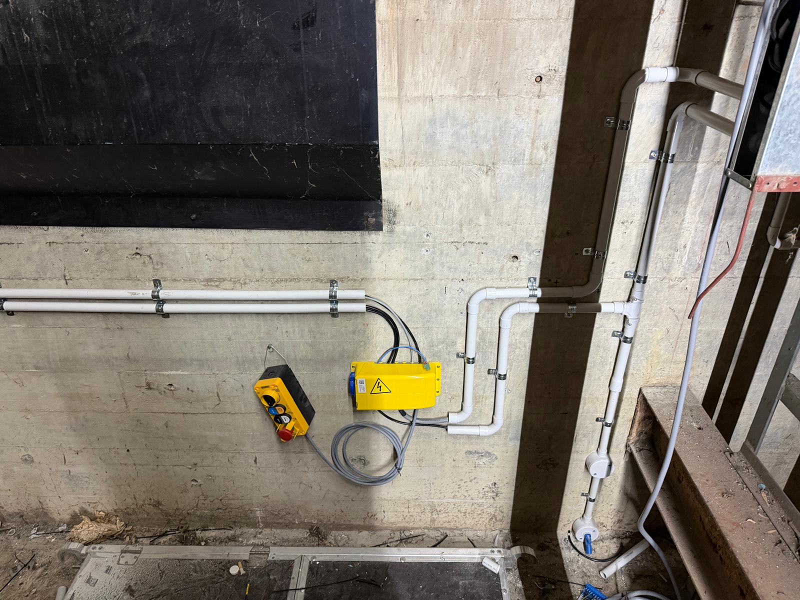 Lift pit electrical installation showing conduit and enclosed controls
